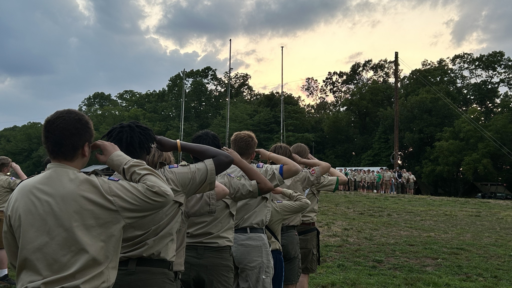 Scouts saluting during flag ceremony at camp